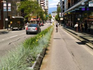 Biking in Vancouver, separated from cars by a physical median. (Flickr, via Jeff Arsenault)